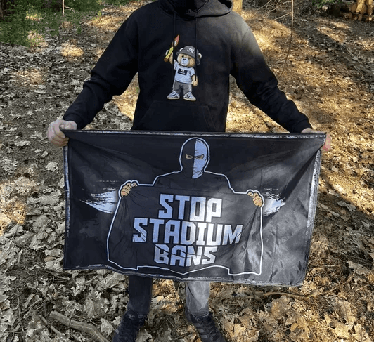 Football supporter holding a Stop Stadium Bans flag
